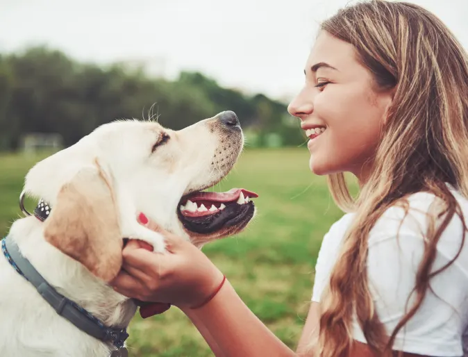 Dog and woman looking at each other smiling
